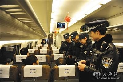 2015年1月8日,在呼和浩特开往包头的动车上,呼和浩特铁路公安处乘警正在对旅客的身份证进行查验。图/视觉中国