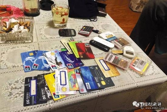 11月28日晚,燕郊东方夏威夷南岸二期10号楼501室,一名C1家长(传销头目)向刘奇等人展示自己的18 张银行卡和信用卡。 新京报记者大路摄